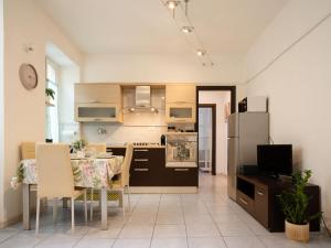 a kitchen and dining room with a table and a refrigerator at Nel centro storico di Ovada in Ovada