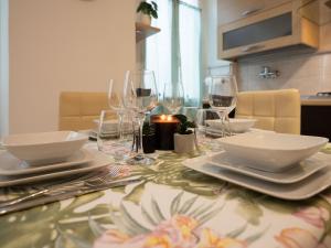 a table with plates and wine glasses on it at Nel centro storico di Ovada in Ovada