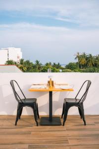 a table and two chairs on a patio at Oasis Retreat Dhiffushi in Dhiffushi