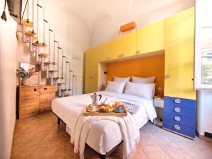 a bedroom with a large bed with a tray on it at Rivierarent Casa Nemo in Finale Ligure