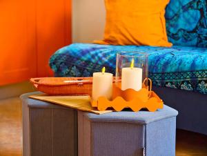 a table with two candles on top of it with a bed at Rivierarent Casa Nemo in Finale Ligure +2 photos