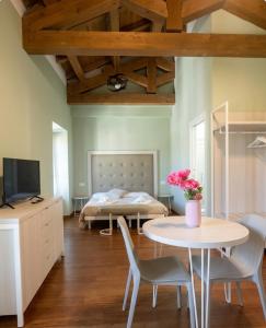 a bedroom with a bed and a table and chairs at Hotel Ristorante Fontana in Calestano