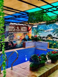 a room with plants and a mural on the wall at Akrafthaus by KAVKANZ in Abuja
