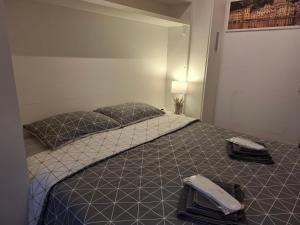 a bedroom with a bed with two phones on it at L'Ancora in Rapallo