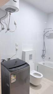 a white bathroom with a toilet and a sink at Villa Al Khair in Medina +10 photos