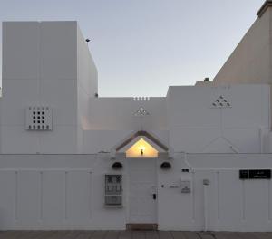 a white building with a door and a window at Villa Al Khair in Medina