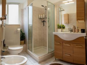 a bathroom with a shower and a toilet and a sink at Nel centro storico di Ovada in Ovada
