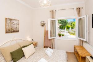 a bedroom with a bed and a window at Pipetos house in Acharavi