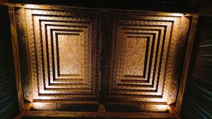 an old wooden door with intricate designs on it at Villa Joglo Kawung - City Centre Paradise with Pool in Yogyakarta
