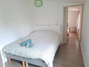a bedroom with a bed with two shoes on it at L'ESPOIRENTHESE T2 35m2 in Nieuil-lʼEspoir