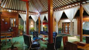 a living room with a table and chairs at Villa Joglo Kawung - City Centre Paradise with Pool in Yogyakarta