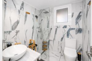 a bathroom with a white toilet and a sink at Pipetos house in Acharavi +58 photos