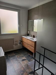 a bathroom with a sink and a window at Le reflet de la cathédrale in Saint-Omer +8 photos