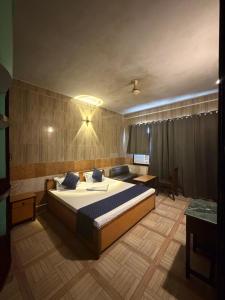 a bedroom with a large bed in a room at Hotel Gangotri in Bahāsi