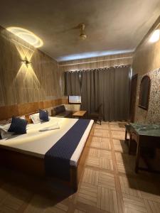 a bedroom with a large bed in a room at Hotel Gangotri in Bahāsi