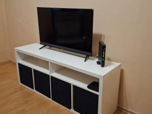 a white entertainment center with a tv on top of it at M&O Belgrade in Belgrade