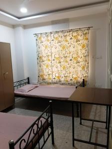 a room with two beds and a curtain at Nasa Hostel in Panchanai