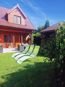 a group of lawn chairs sitting in the grass at Diament Rogowo in Rogowo