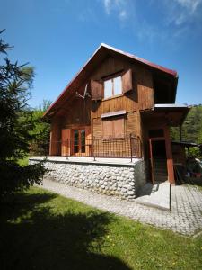 a large wooden house with a stone wall at Chata U Jozefa in Malý Lipník +21 photos
