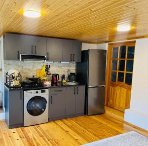 a kitchen with a stove and a dishwasher at The House 39 in Sheki