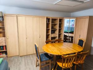a dining room with a wooden table and chairs at Altstadthaus Marille mit Innenhofterrasse in Melk +20 photos