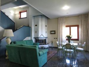 a living room with a couch and a table at Villa Ara Dell'Etna in Pedara +24 photos