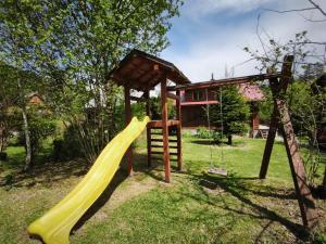 a playground with a slide and a play structure at Chata U Jozefa in Malý Lipník