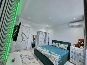 a bedroom with a bed and a teddy bear at Sejur la mare in Mangalia +7 photos