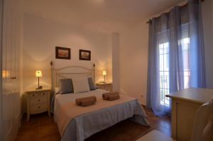 a bedroom with a bed with two towels on it at Playa Grande SOLMARES in Isla del Moral +69 photos