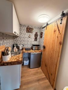a small kitchen with a sink and a stove at Domek KALINKA -Góry Sowie-Rzeczka in Rzeczka