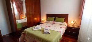 a bedroom with a large bed and a mirror at Casa Lali in Redondela