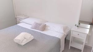 a bedroom with a bed with two towels on it at GuestHouse Gentile Caruso in Torrenova +24 photos