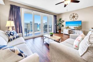 a living room with two couches and a large window at Laketown Wharf 903 in Panama City Beach