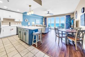 a kitchen and living room with a table and chairs at Laketown Wharf 903 in Panama City Beach