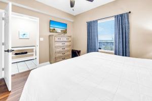 a bedroom with a large white bed and a window at Laketown Wharf 903 in Panama City Beach +46 photos