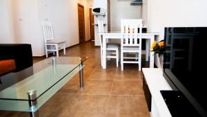a living room with a glass table and chairs at Plaza de la Luz Cádiz in Cádiz