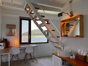 a room with a staircase and a desk and a window at maisonde ojolac in Kosŏng-ni