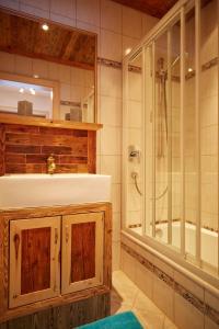 a bathroom with a sink and a shower and a tub at Appartement Gassner in Leogang