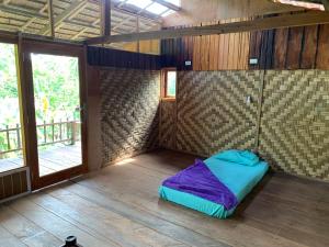 a room with a bed in the corner of a room at Cucu Suzanne in Lasikin