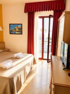 a hotel room with a bed and a window at B&B Marina Sleep And Ship in Rodi Garganico