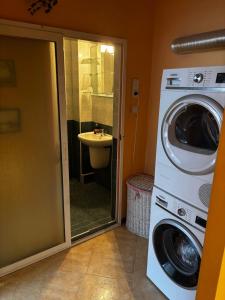 a washer and dryer in a bathroom with a sink at Голям двустаен апартамент in Burgas