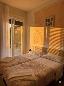 a large bed in a bedroom with a window at Villa Emma in Nago-Torbole