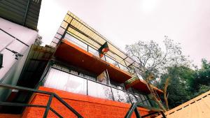 an orange building with a fence next to it at Hillora Coastal Resort Goa in Arpora +7 photos