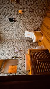 a view of a bathroom with a stone floor at Hillora Coastal Resort Goa in Arpora