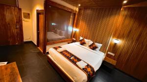 a bedroom with a large bed in a room at Hillora Coastal Resort Goa in Arpora
