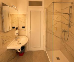 a bathroom with a sink and a shower at Villa Emma in Nago-Torbole +14 photos