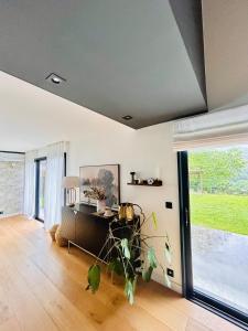 a living room with a table and a large window at Villa premium avec extérieur ensoleillé in Urrugne