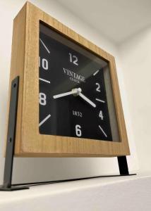 a wooden clock sitting on top of a table at Joyau historique 101 in Aurillac