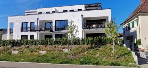 a white building with a balcony on the side of it at See-Eck in Überlingen