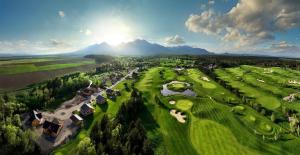 an aerial view of a golf course with mountains in the background at Vila Valentina Luxury Chalet in High Tatras in Veľká Lomnica